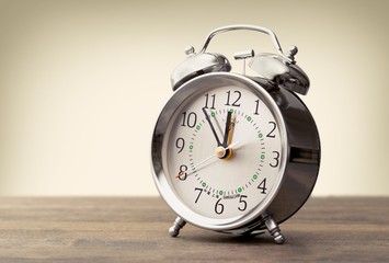 Clock. Vintage background with retro alarm clock on table