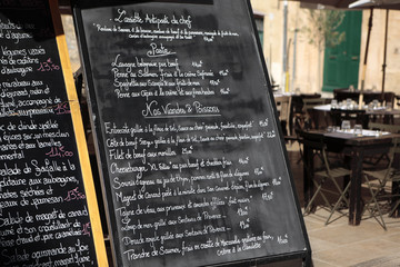 Paris France French restaurant with chalk menu board and customer seating in the background photo