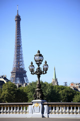 Fototapeta na wymiar Renaissance street lamp on alexander bridge with Eiffel Tower in the distance photo