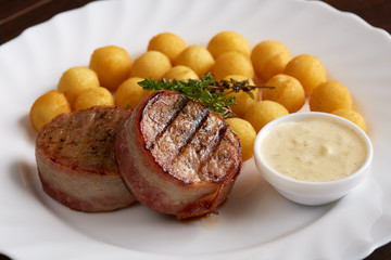 Delicious grilled meat with sauce and cheese balls