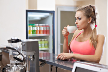 Sportive woman with cup in the gym bar - 82519601