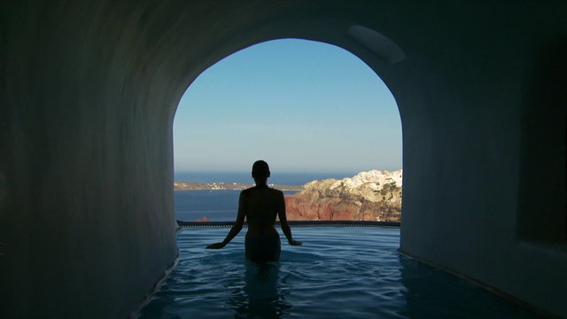 A woman getting out of a luxurious pool