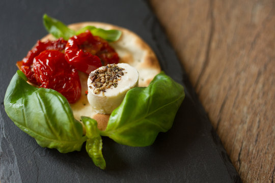 crackers with goat cheese, sun-dried tomatoes and basil