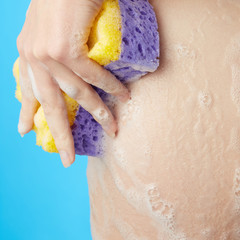 Woman's body. Ass in foam of shower gel with wisp of bast