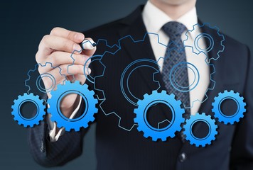 Business. Businessman hand draws gear to success concept