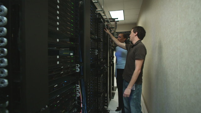 two people in a server room