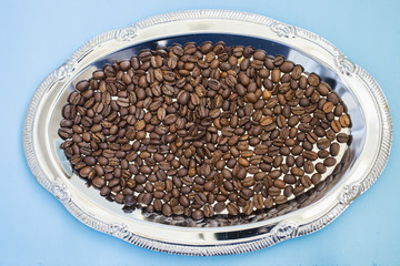 grains of coffee are scattered on a tray