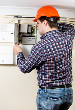electrician installing components in electrical shield