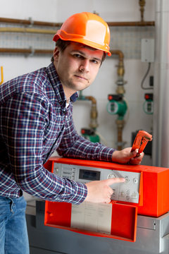 engineer adjusting heating work on automated control dashboard