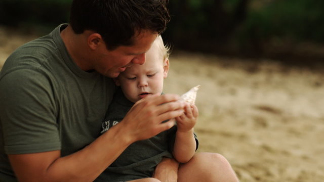 father and baby at the beach