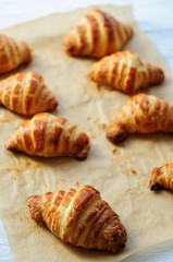 Fresh baked croissants on baking paper