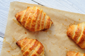 Fresh baked croissants on baking paper