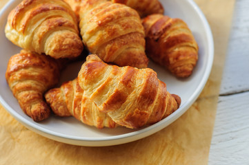 Fresh baked croissants on baking paper