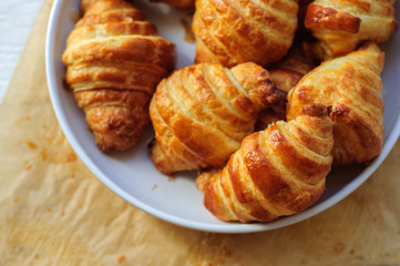 Fresh baked croissants on baking paper