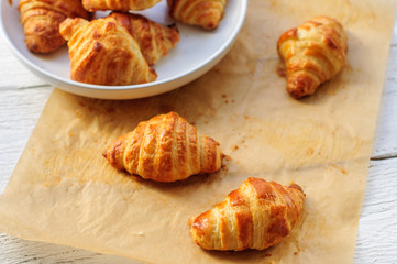Fresh baked croissants on baking paper