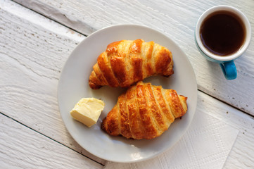 Breakfast with fresh baked croissants, butter and coffee
