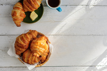 Breakfast with fresh baked croissants, butter and coffee
