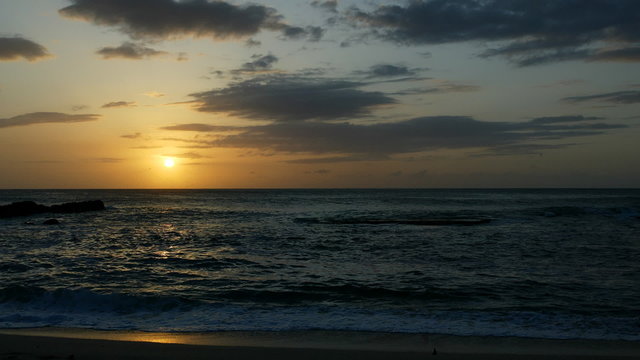 Time lapsed view of a beach shoreline fading to black
