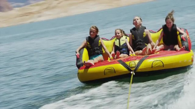 BOAT POV WS PAN Tourists (6-15) on inflatable raft / Lake Powell, Utah, USA