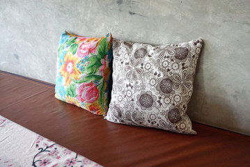 Colorful flower pattern throw cushion on brown seating