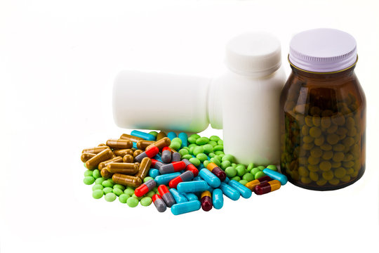 colorful pills and tablets on white background