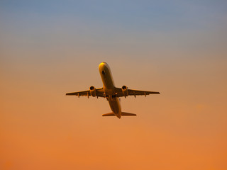 Fototapeta na wymiar Airplane leaving airport at the sunset