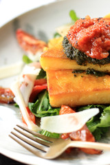 italian cuisine polenta served with bolognese sauce and lettuce
