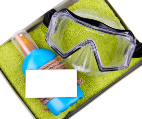Gift set - green towel, blue bottle of suntan spray