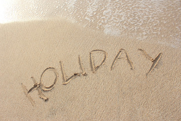 sand beach with "holiday" word