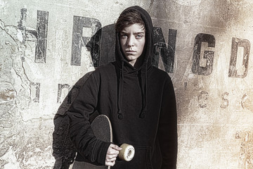 vintage shoot of a teenage boy holding his long board