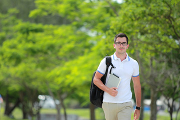 Fototapeta premium college student walking by at college park