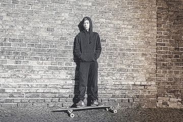 black and white shoot of a teenage boy with hoodie standing on a