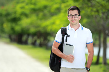 Fototapeta premium happy smiling college student at college park