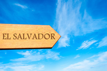 Wooden arrow sign pointing destination EL SALVADOR