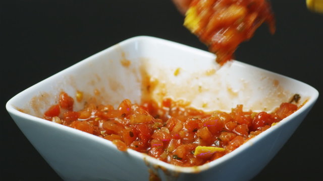 dipping chips in salsa