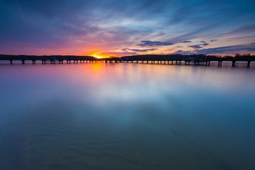 Naklejka na ściany i meble Colorful sunset over lake