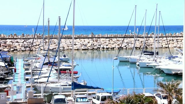 marina with yachts on blue sea and sky background 