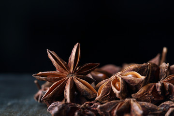 Star anise seeds on the wooden table. Black background