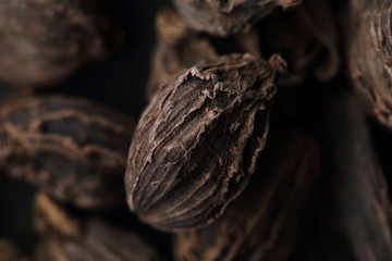 Seeds of black cardamom. Macro. Blurred background