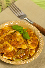 Spinach stuffed ravioli with tomato sauce and parmesan cheese