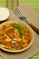 Spinach stuffed ravioli with tomato sauce and parmesan cheese