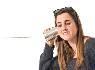 girl listening through a tin phone