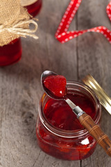 Strawberry Jam on old wooden background. Selective focus.