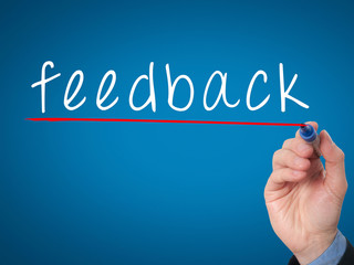 feedback concept with businessman hand writing.
