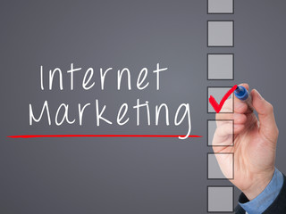 Business hand writing internet marketing and check listing task