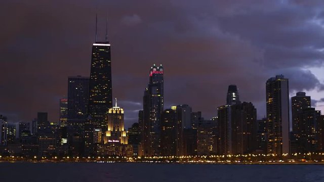 T/L WS Chicago skyline across Lake Michigan against cloudy sky at dusk, Chicago, Illinois, USA