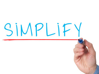 Businessman hand writing Simplify with marker
