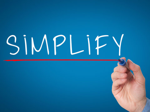 Businessman hand writing Simplify with marker