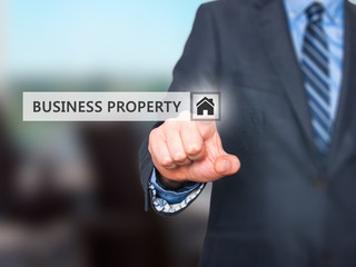 Fototapeta na wymiar Businessman pressing business property button