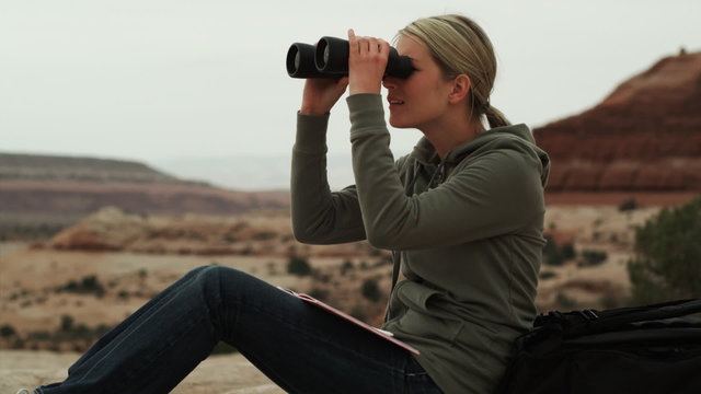 woman with binoculars in the desert
